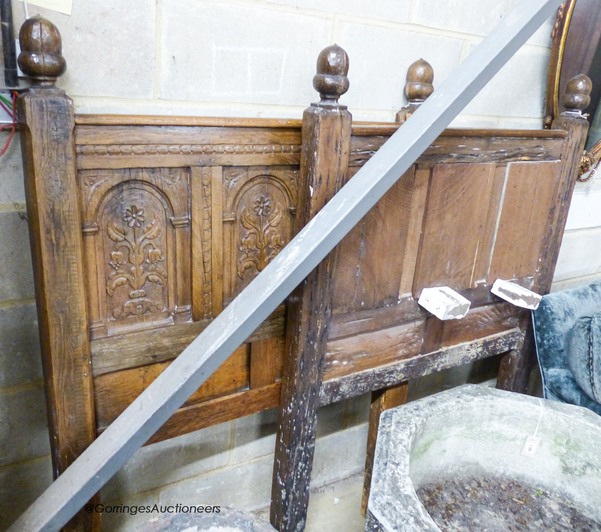 A pair of late 19th century panelled oak single bedsteads with floral carving, width 108cm, height 156cm